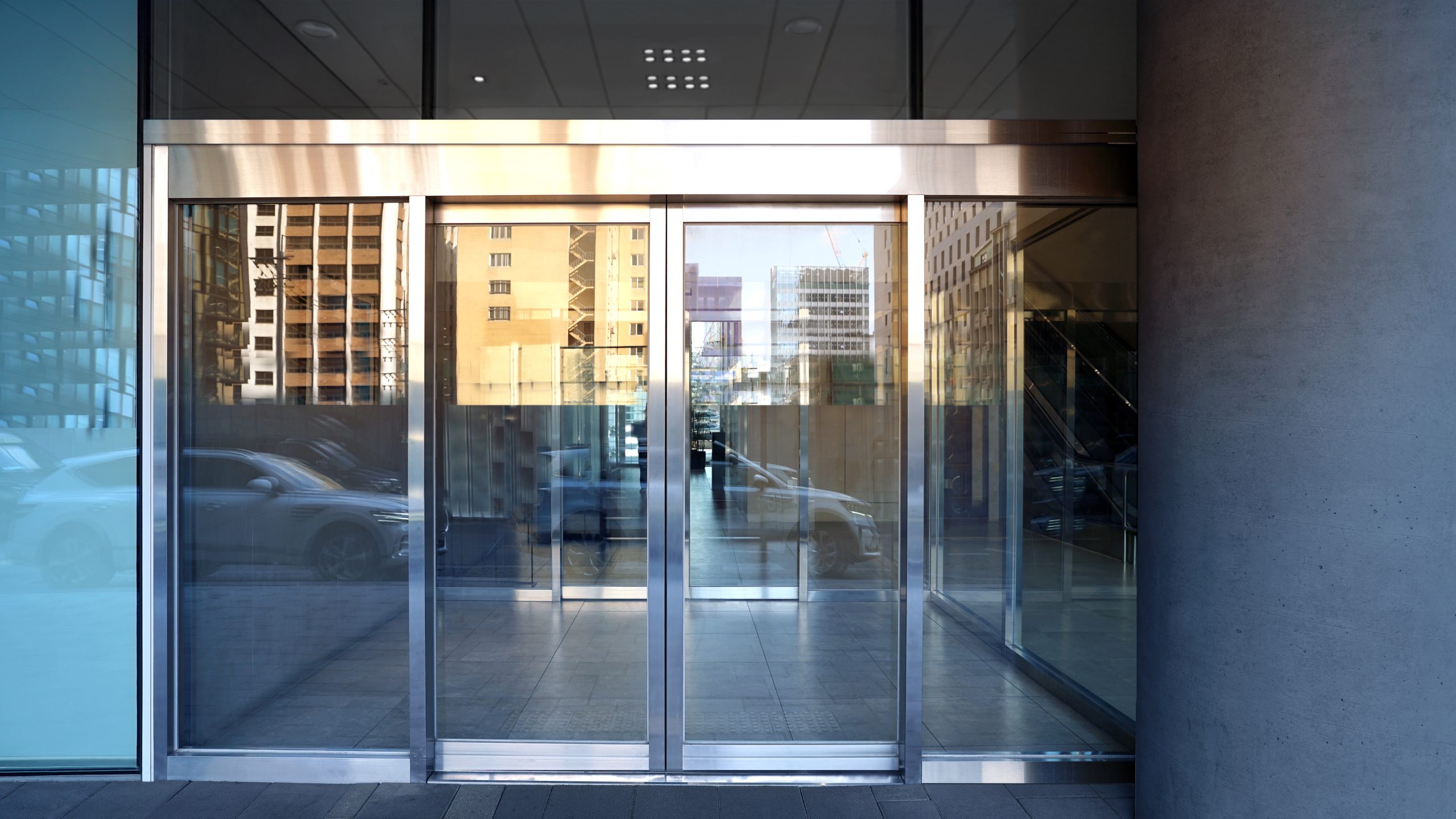 Modern automatic sliding glass door at a commercial building entrance in Toronto
